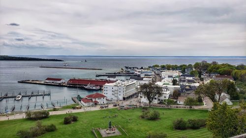 High angle view of buildings by sea against sky