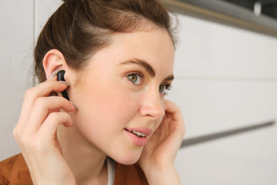 Close-up of young woman looking away