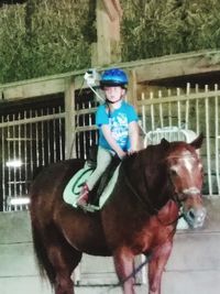 Portrait of smiling boy with horse