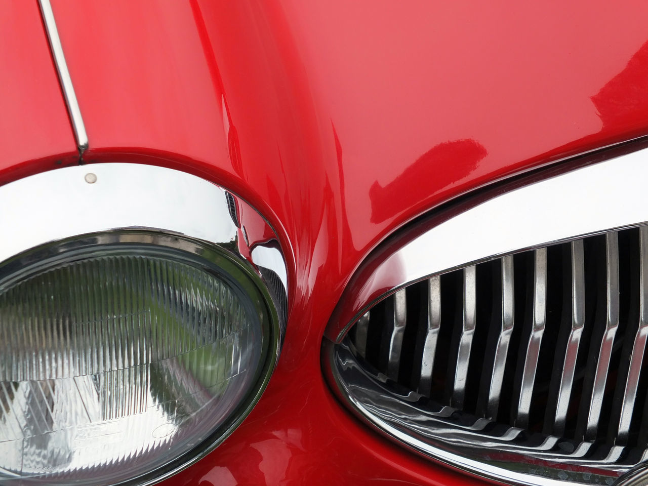 CLOSE-UP OF RED CAR MOVING