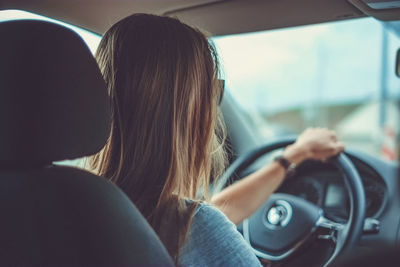 Rear view of woman in car