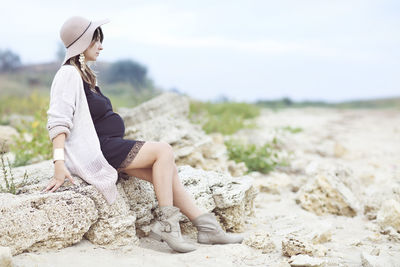 Woman sitting on rock