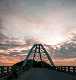 View of suspension bridge against sky during sunset
