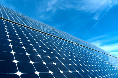 Low angle view of solar panel against blue sky