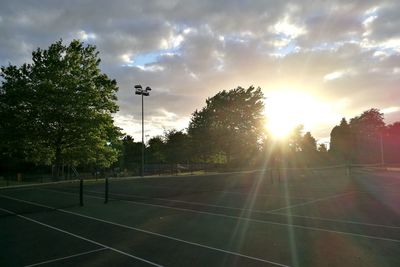 Scenic view of soccer field against sky during sunset