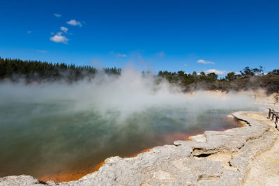 Scenic view of waterfall against sky