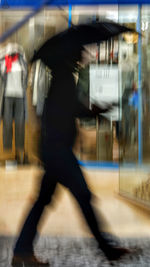 Blurred motion of man walking in subway station