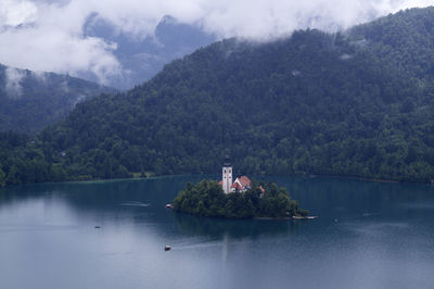 Scenic view of sea and mountains against sky