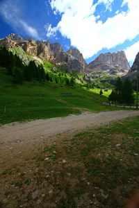 Scenic view of field and mountains against sky