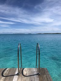 Scenic view of swimming pool by sea against sky