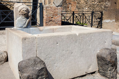 Antique water fountain on the streets of the ancient city of pompeii