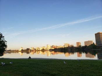 Scenic view of lake by buildings against sky