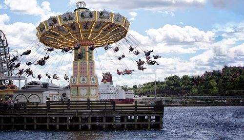 Amusement park ride against sky