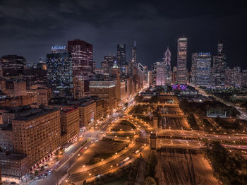 High angle view of illuminated buildings in city at night