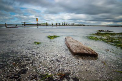 Scenic view of sea against cloudy sky