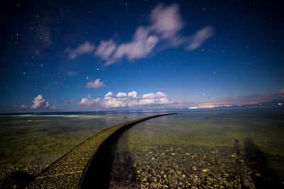 Scenic view of road against sky at night