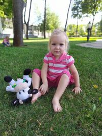 Portrait of cute girl sitting at park