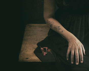 Woman in black dress with dried flowers in her hand vi