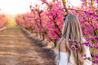 Rear view of woman standing on footpath