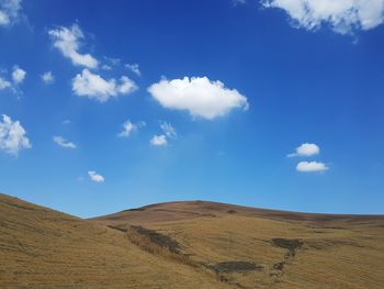 Scenic view of landscape against blue sky