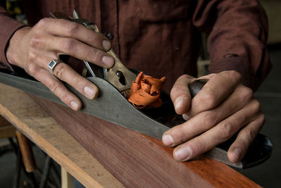 Midsection of carpenter in workshop