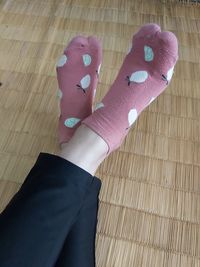 Low section of person wearing shoes on floor