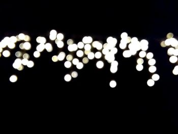 Illuminated lights over black background