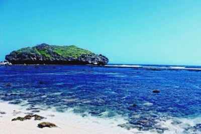 Scenic view of sea against clear blue sky