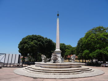 Statue in park against clear sky