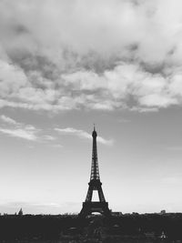 Tower against cloudy sky