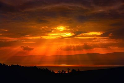 Scenic view of sea against romantic sky at sunset