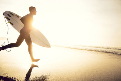 Man standing on beach against sky