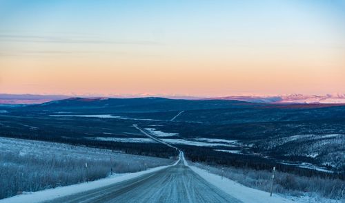 Empty road against sky during winter