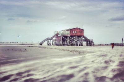 Scenic view of beach against sky during winter