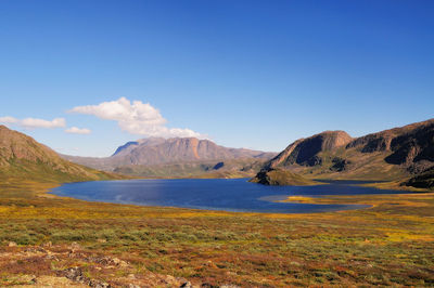 Scenic view of mountains against blue sky