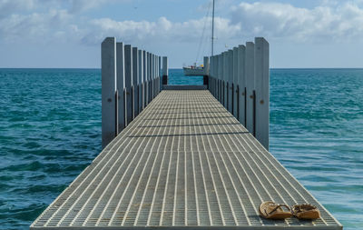 Close-up of pier on sea against sky