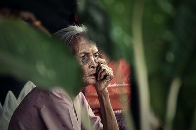 Old woman looking away outdoors