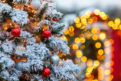 Close-up of illuminated christmas tree in snow