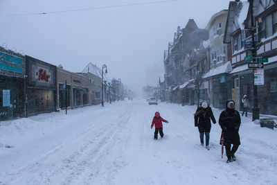 Woman covering face covered with snow