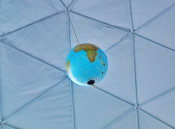 Low angle view of blue glass ceiling