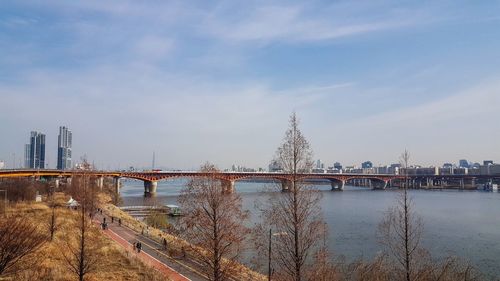 Bridge over river with city in background