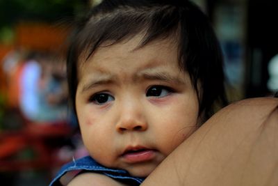 Close-up portrait of cute girl looking away