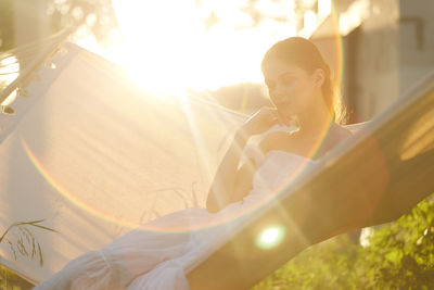 Portrait of young woman holding flower bouquet
