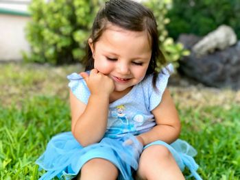 Close-up of girl sitting on grass