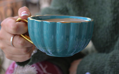 Cropped hand of woman holding drink