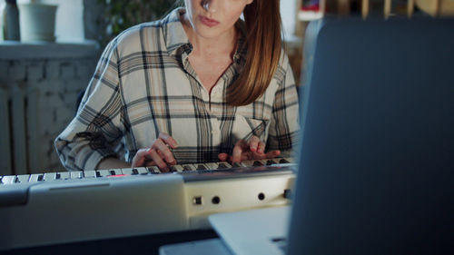 Young woman using laptop at home