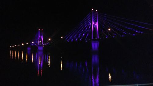 Illuminated built structure against blue sky at night