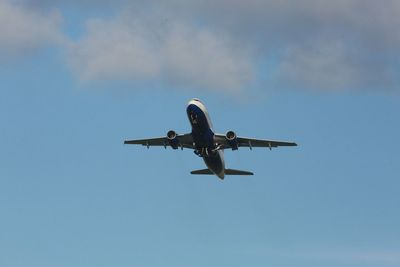 Low angle view of airplane flying in sky