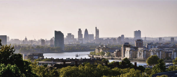 Buildings in city against clear sky