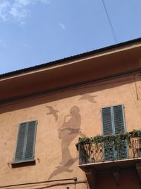 Low angle view of building against clear blue sky